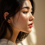 Load image into Gallery viewer, Sterling silver ear cuff lifestyle photo — worn on inner ear cartilage fold, three-quarter face profile
