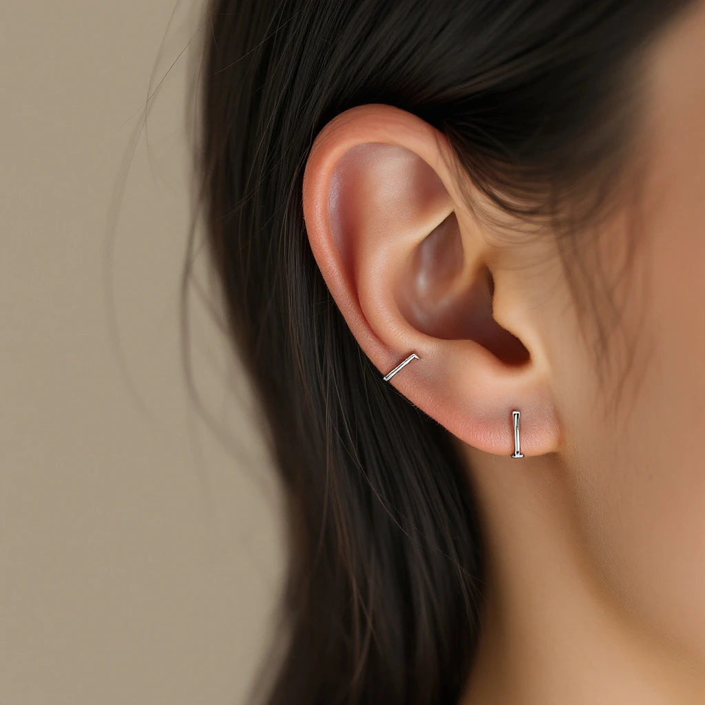 Sterling silver ear cuff clipped onto inner anti-helix cartilage — no piercing required, close-up lifestyle